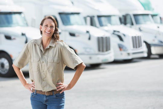 woman in front of fleet of trucks